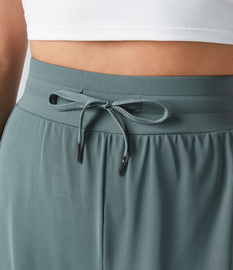 hochgeschnittene yogahose mit kordelzug kontrastfarbenem mesh-gewebe 2-in-1-tasche und fließendem weitem bein